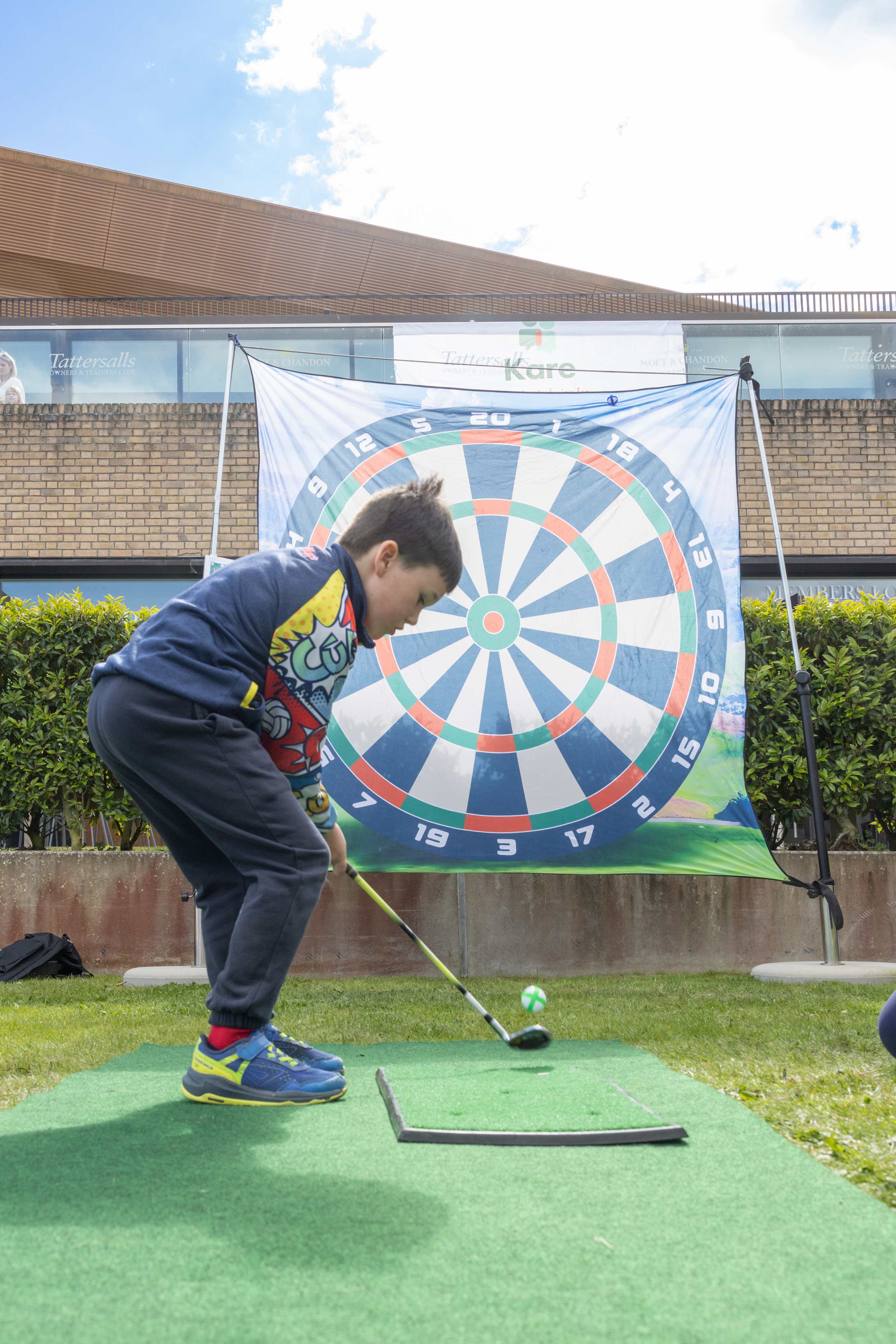 Child swinging golf club. 